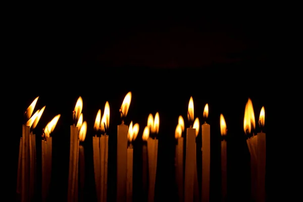 Многие Рождественские Свечи Горят Ночью Черном Фоне Свечное Пламя Изолировано — стоковое фото