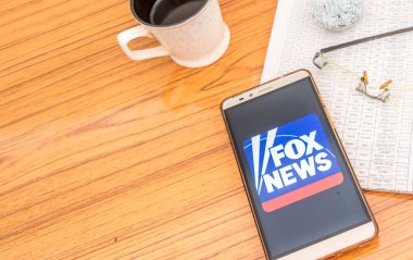 Kolkata, Hindistan, 3 Şubat 2019: Fox Haber app (uygulama) güzel bir gazete ve bir fincan kahve ile ahşap bir masa üzerine yerleştirilen cep telefonu ekranda görünür. Bir teknoloji ürün çekimi.