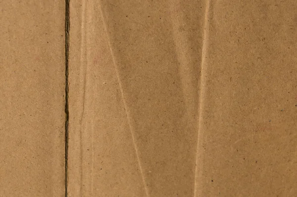 Superficie de corte y rasgado hoja marrón color viejo y vintage caja de papel de cartón. Fondo de textura abstracta de cerca. Fondo de patrón de lona natural. Estudio con espacio de copia para texto. — Foto de Stock