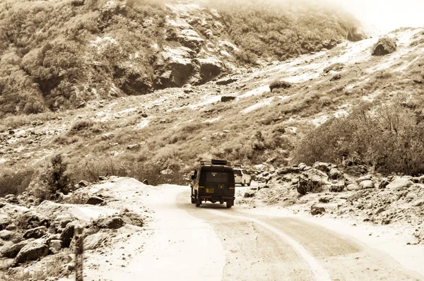 Off-road vehicle goes on the mountain way during the winter rainy season in Himalayan mountain range Gangtok Sikkim India.