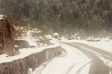 Kışın rüzgarlı karlı sisli çamurlu çamurlu düz adım Himalaya dağ yolu. Leh Manali Highway, Jammu ve Keşmir, Hindistan, Asya.