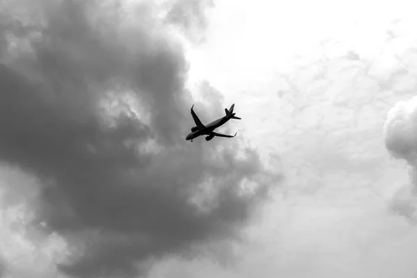 Коммерческий самолет летит в драматических облаках. Концепция путешествий гражданской авиации. Авиационная точка зрения . — стоковое фото