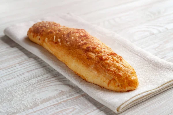 cheese bun, bread with cheese on a white wooden background