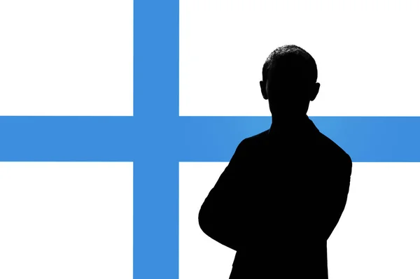 Silhouette di uomo d'affari sullo sfondo della bandiera finlandese . — Foto Stock
