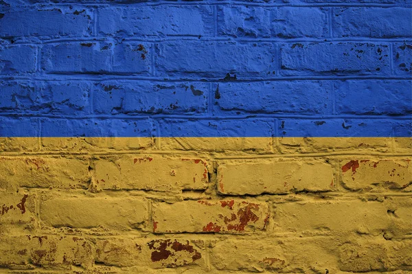 Ukrajinská vlajka na cihlovou zeď na pozadí. — Stock fotografie