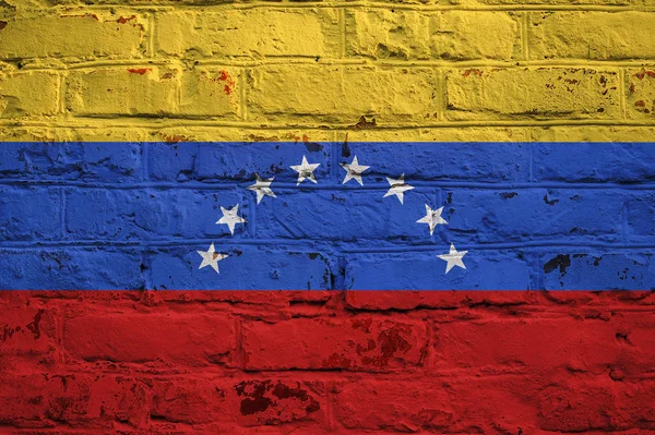 Venezuelan flag on brick wall background.
