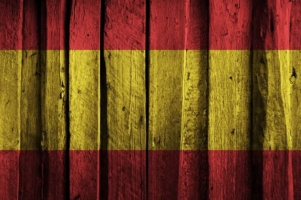 Bandeira espanhola no fundo de velhas tábuas de madeira . — Fotografia de Stock