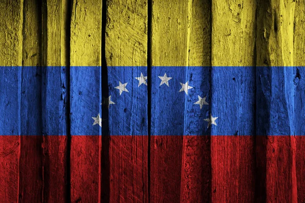 Venezuelan flag on background of old wooden planks.