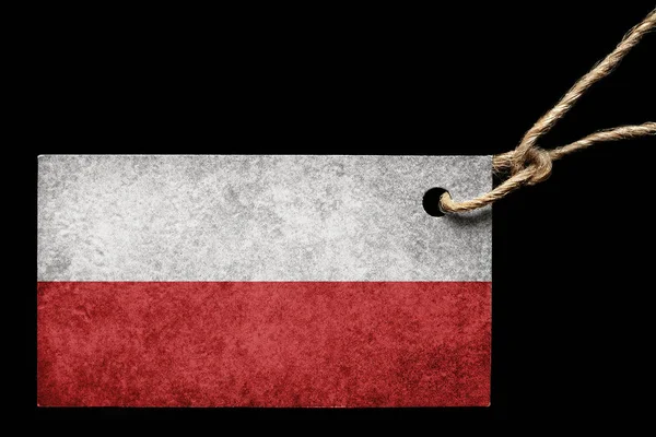 Kartonnen etiket in kleur van de vlag van Polen met een draad op een zwarte achtergrond. — Stockfoto