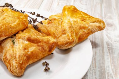 Beyaz plaka üzerinde sebze dolum ve kurutulmuş baharat ile taze çörekler.