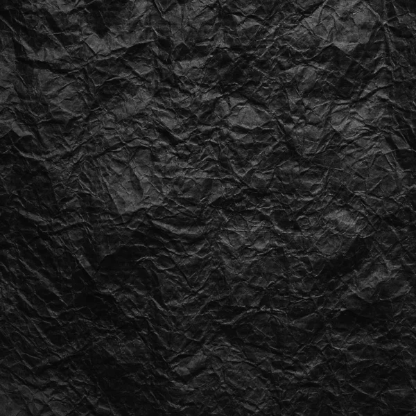 Zerknülltes schwarzes Kraftpapier. Textur aus zerknittertem schwarzem Recyclingpapier. das Konzept des Recyclings und der Wiederverwendung von Papier und Müll. — Stockfoto