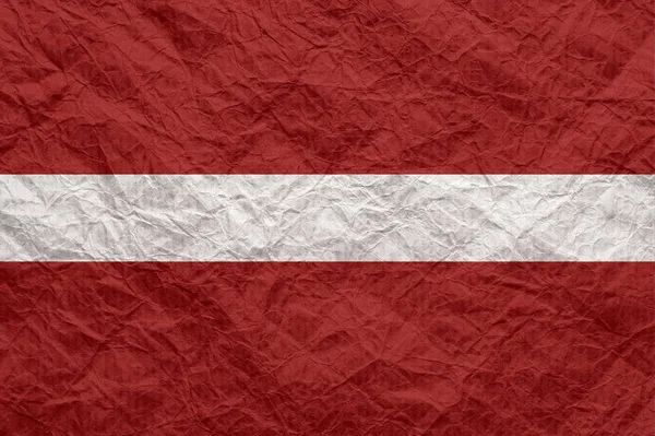 Latvia flag on old crumpled craft paper. — Stock Photo, Image