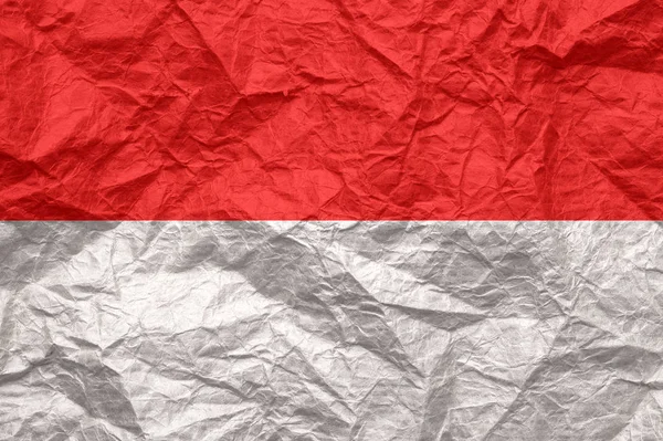 Monaco-Flagge auf altem zerknittertem Bastelpapier. — Stockfoto