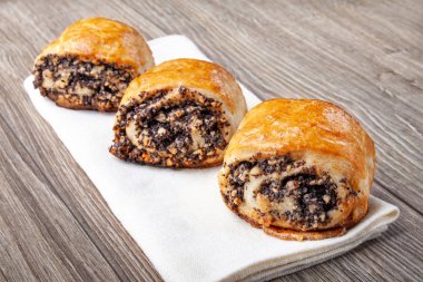 Ahşap bir arka plan üzerinde haşhaş tohumu ile gevrek taze pişmiş kurabiye.