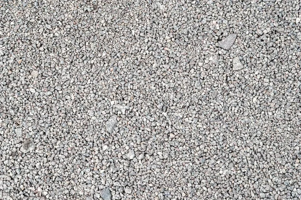 Textura de cascalho. Gravilha de pedra granito cinza claro fino . — Fotografia de Stock