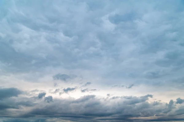 Dark gray clouds. Cloudy windy rainy sky in the evening.