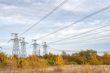 Yüksek voltajlı elektrik hattı. Yüksek voltaj hattının direkleri, bulutlu havada manzara. 