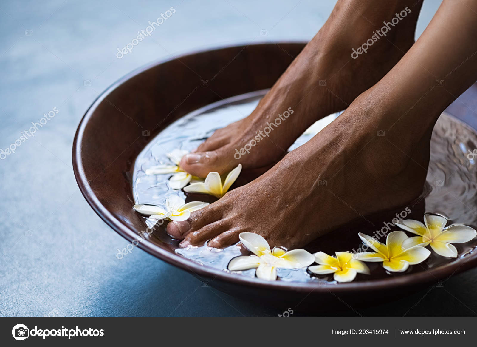 Woman Soaking Feet Bowl Water Floating Frangipani Flowers Spa Closeup