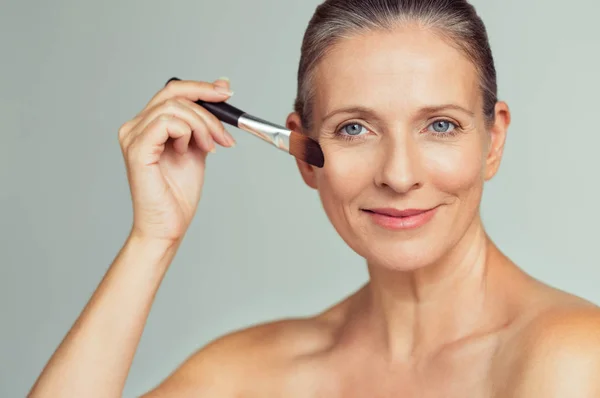 Closeup Portrait Mature Woman Applying Tonal Foundation Face Makeup Brush — Stock Photo, Image