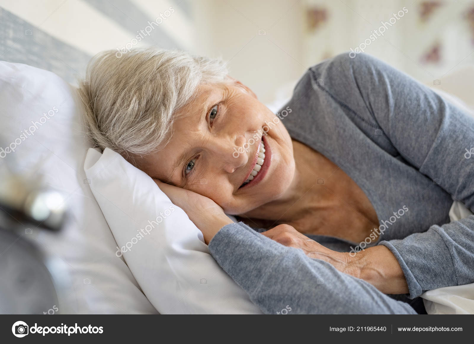 Femme Agee Souriante Reposant Sur Lit Regardant Camera Reveillez Vieille Photo de stock par ridofranz 211965440