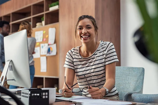 Portrait Smiling Young Business Woman Holding Eyeglasses Sitting Creative Agengy — Stock Photo, Image