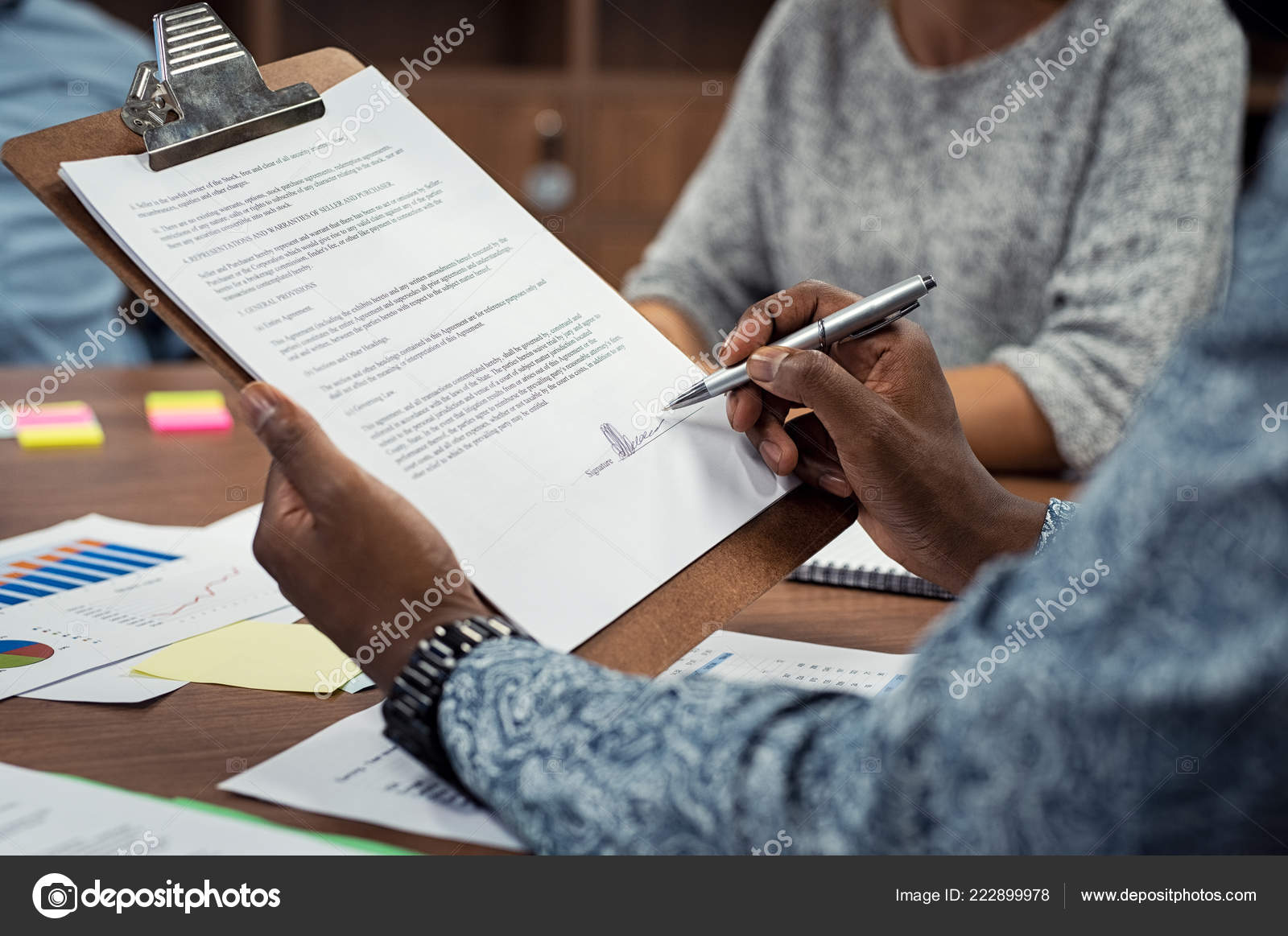 closeup african american businessman signing contract cafe manager resume
