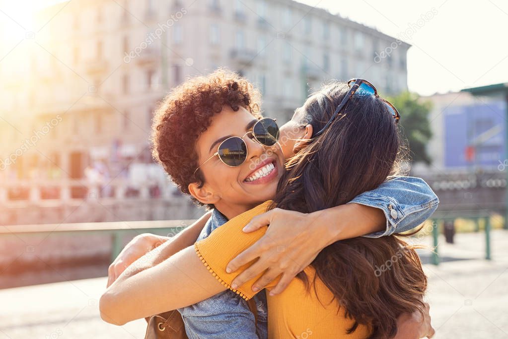 Two women hugging in town square