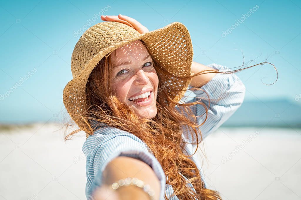 Smiling mature woman with straw hat