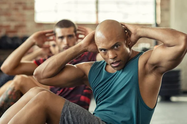 Men doing sit ups workout — Stock Photo, Image