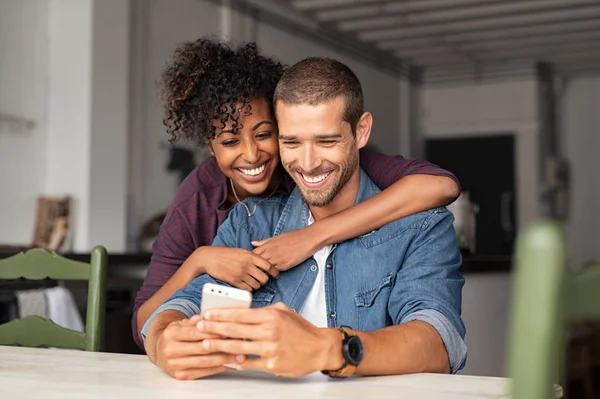 Lyckligt par tittar på telefon tillsammans — Stockfoto