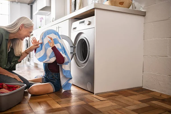 Grandma and granddaughter playing with clothes — Stock Photo, Image