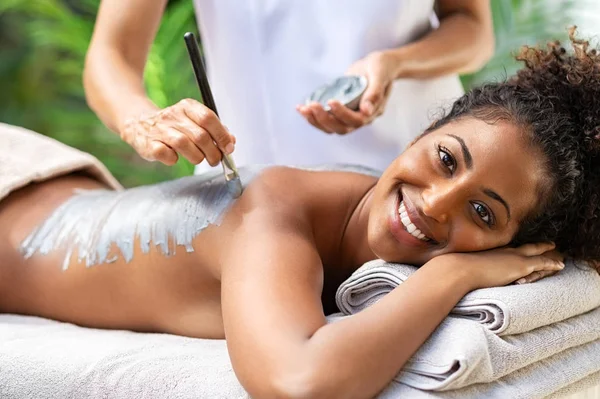 Woman relaxing during peeling with mud — Stock Photo, Image