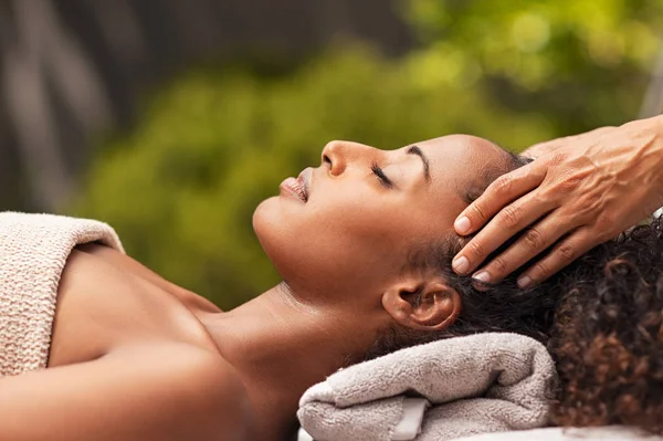 Mulher africana bonita relaxante com massagem facial — Fotografia de Stock