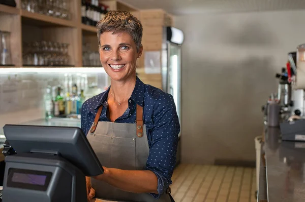 Owner at bar counter smiling — Stock Photo, Image