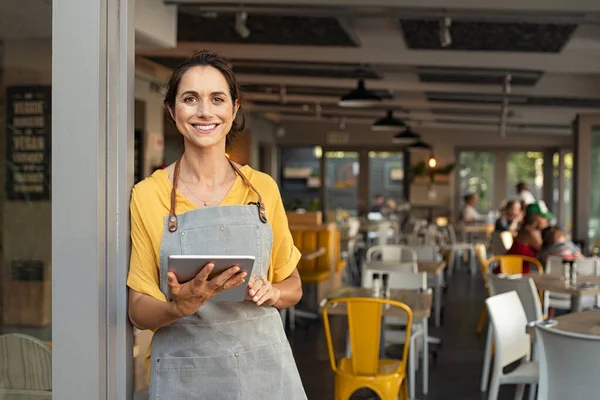 Small business owner at entrance looking at camera — Stock Photo, Image