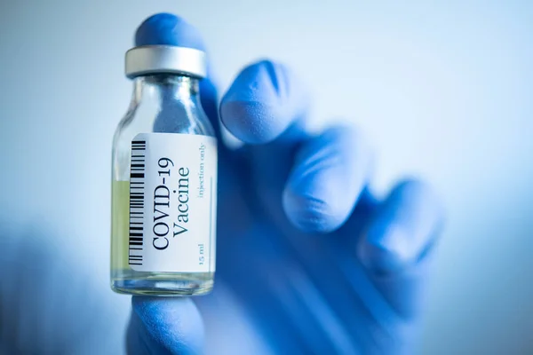Close Doctor Hand Wearing Blue Disposable Gloves Showing Vaccine Phial — Fotografia de Stock