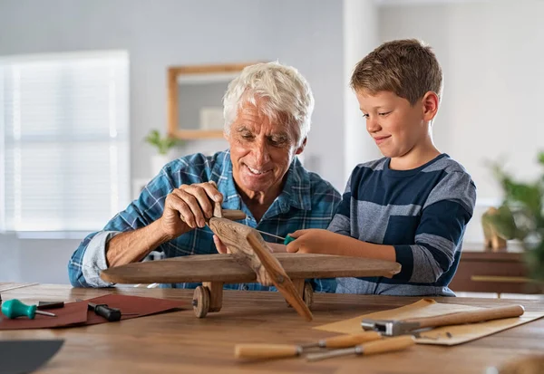 Senior Man Helping Child Screw Airplane Part Building Together Summer — Stock Photo, Image