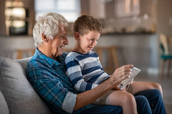 Nipote Seduto Sulle Ginocchia Del Nonno Durante Utilizzo Tablet Digitale — Foto Stock