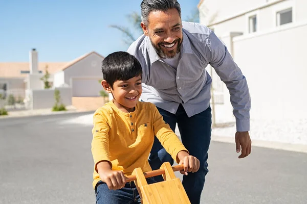 Cheerful Middle Eastern Father Helping Excited Son Ride Wooden Balance — Stock Photo, Image