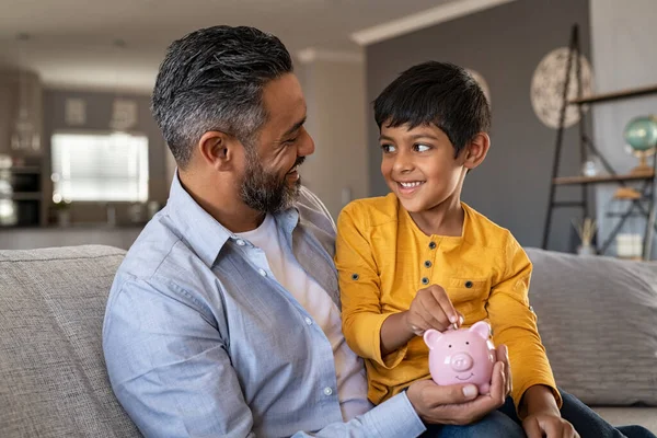 Indian Father Smiling Son Putting Coin Piggy Bank Smiling Boy — Stock Photo, Image