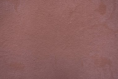 Kırmızı sıva çimento duvar.