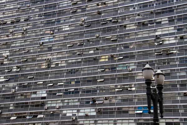 Enorme edificio de negocios antiguo con poste de iluminación vintage en frente de él — Foto de Stock