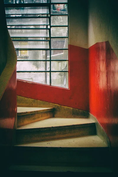 Spiral staircase with red and white walls.