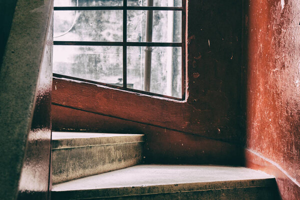 Steps of a staircase with red and white walls.