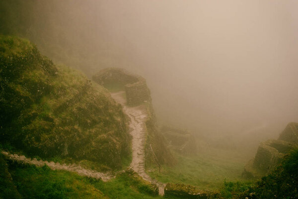 Ancient stone ruins in mist on the Inca Trail. Peru. South America. No people.