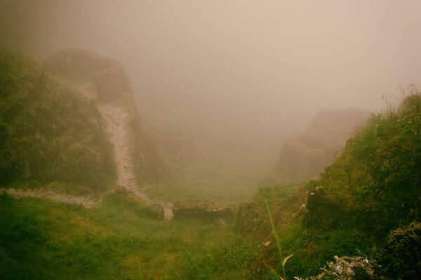Ancient stone ruins in mist on the Inca Trail. Peru. South America. No people.