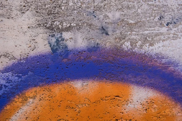 Orange and purple paint on a concrete wall. Stock Photo