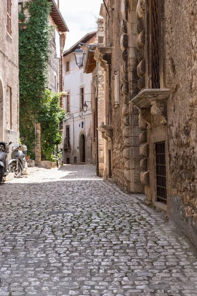 stock image Scooter and bicycle parked on a medieval town.