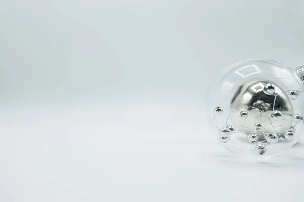 Transparent christmas ball with silver spheres and silver bauble