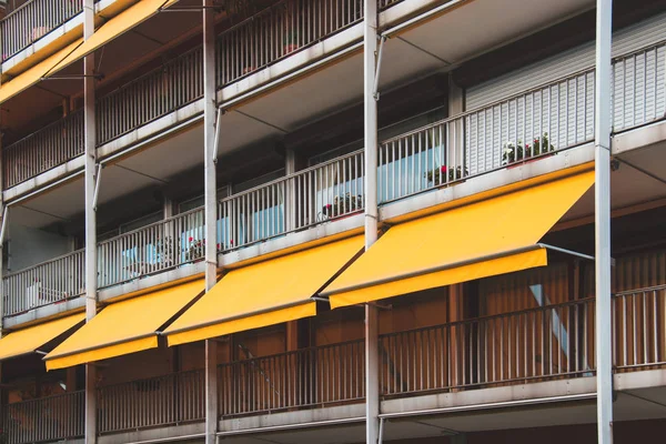 Mooi balkon met gele luifel in appartementenhuis. — Stockfoto